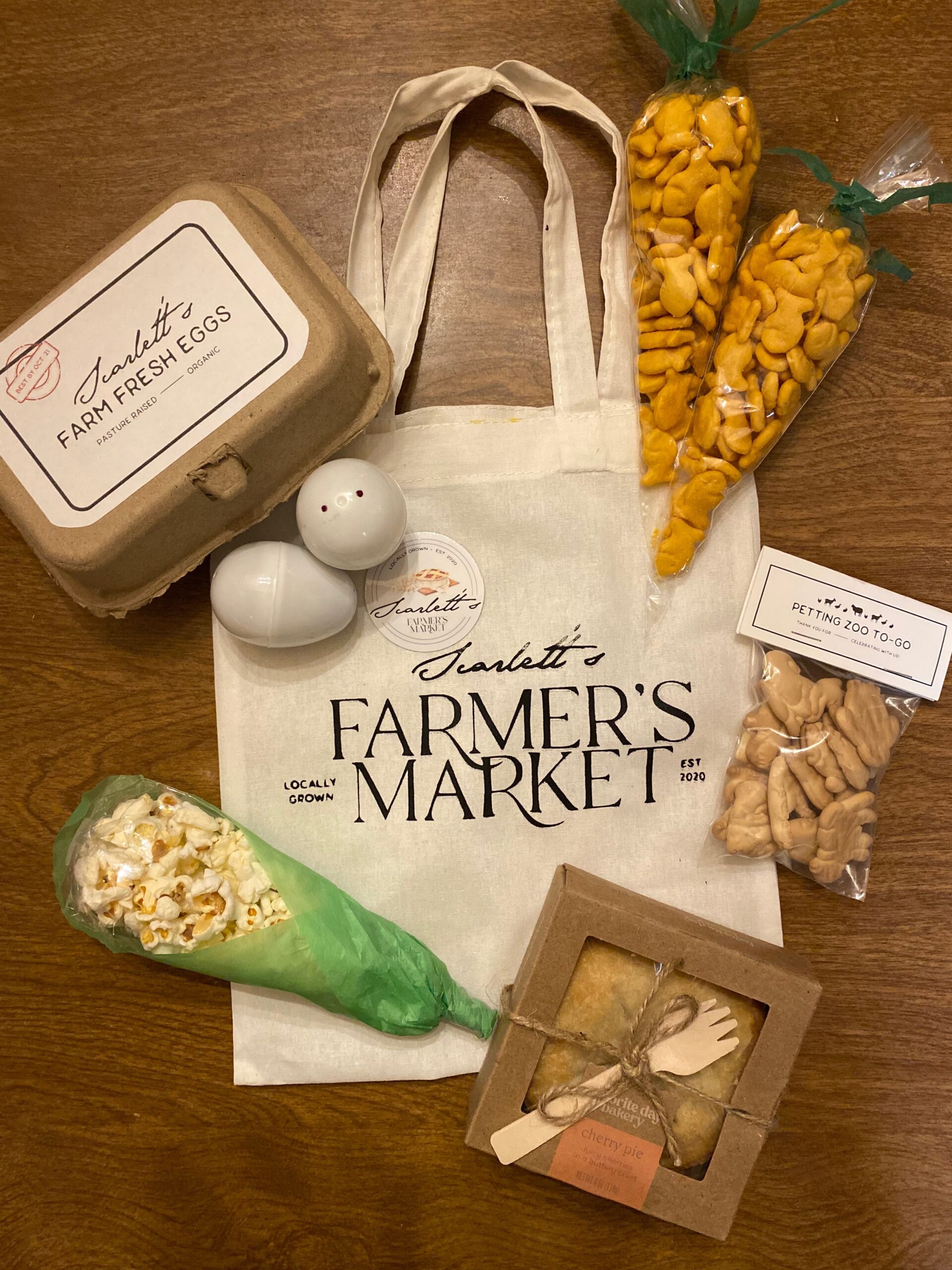 farmers market party favor area with personalized totes and take away goods