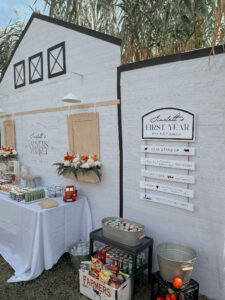Food table backdrop of a personalized Farmers Market  storefront at a farmers market first birthday party!